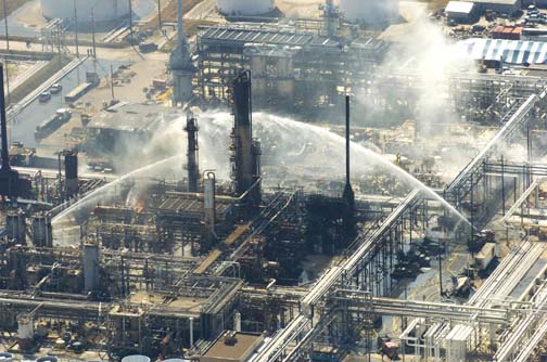 Firefighters battle a blaze and search for victims of an explosion at the BP plant that killed at least 15 people on March 23, 2005, in Texas City, Texas.